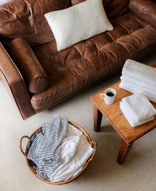 Samantha Lindsey gets ready to fold some laundry with her Article Sven sofa in Chocolat. 