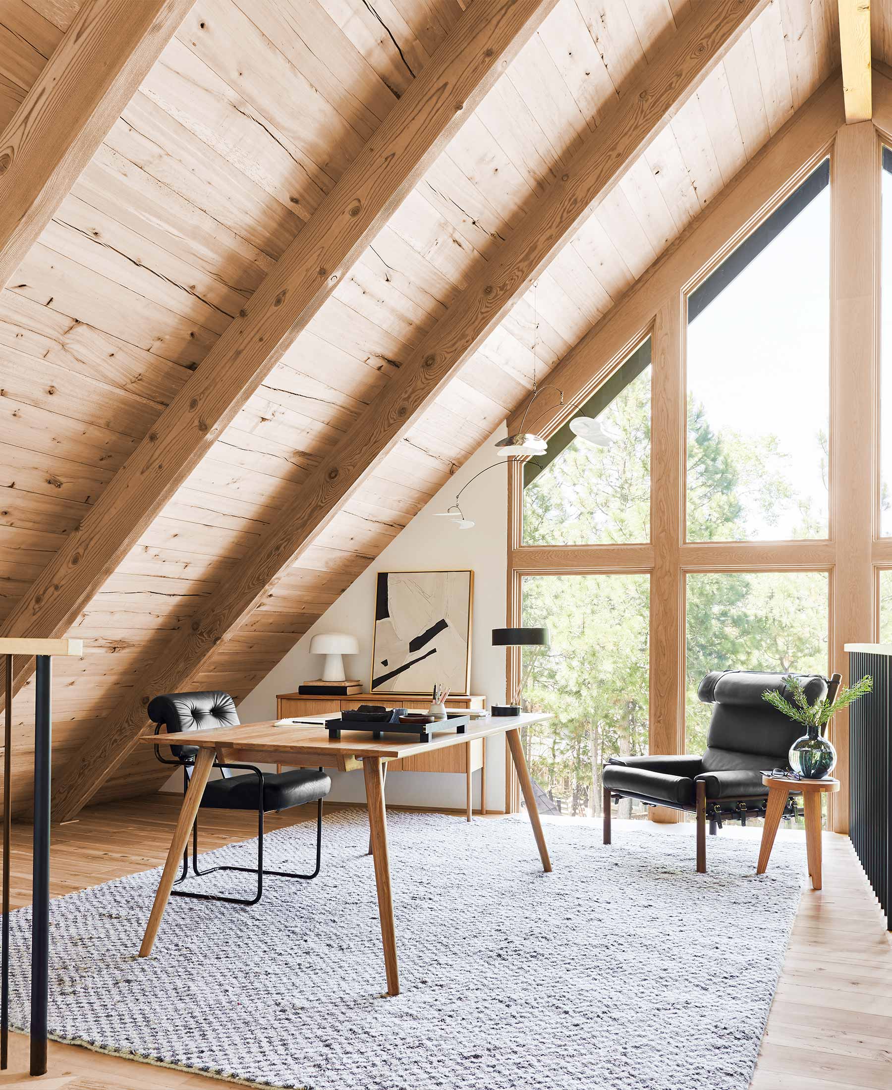 A wood and beam ceiling is featured in this home office space