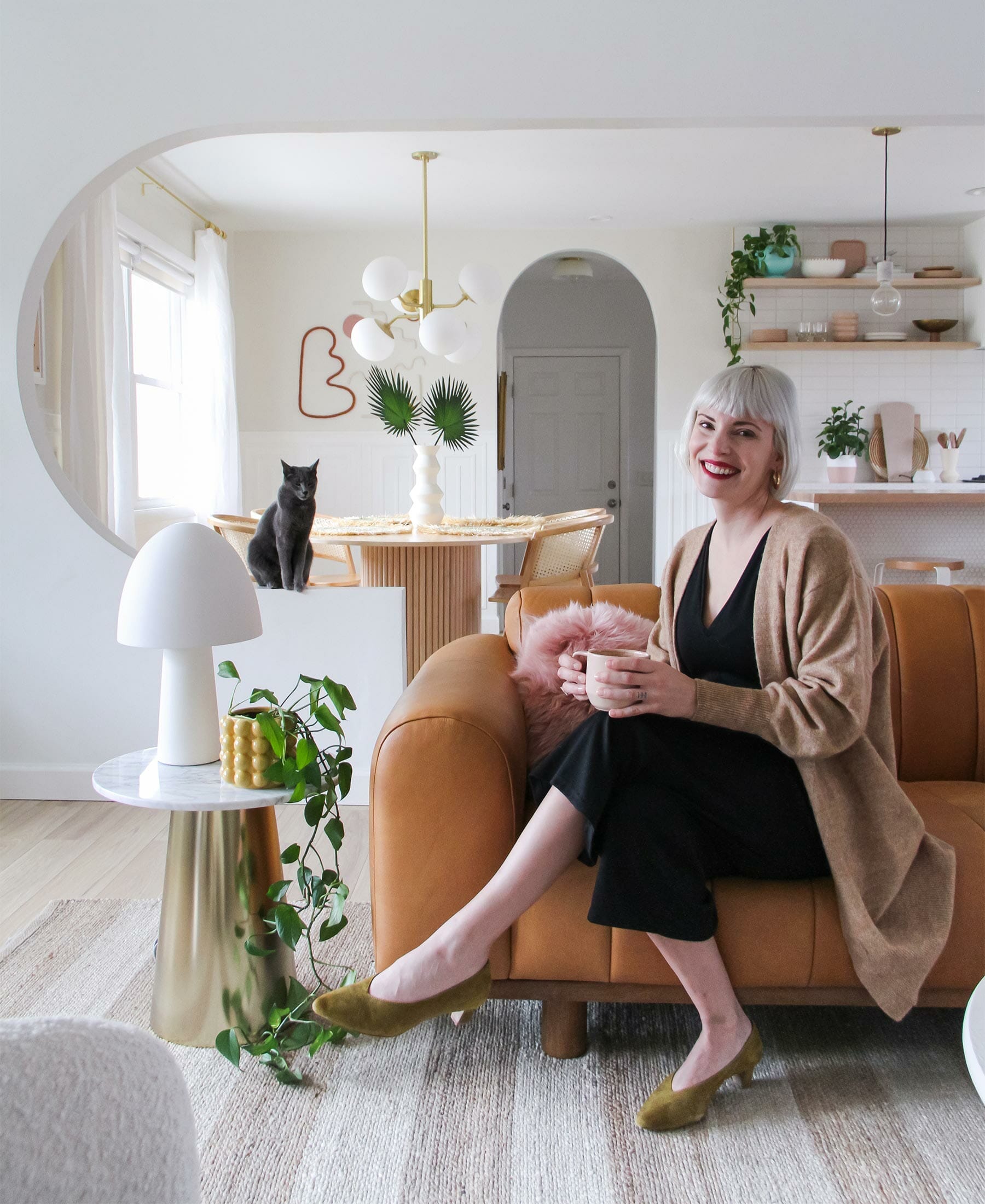 Brit Arnesen of @britdotdesign sits in her modern eclectic living room